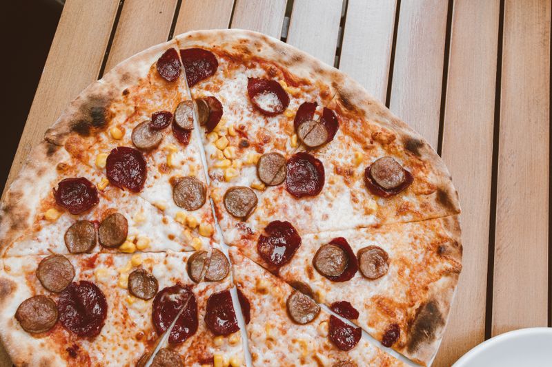 Colourful veggie supreme luce pizza loaded with fresh toppings
